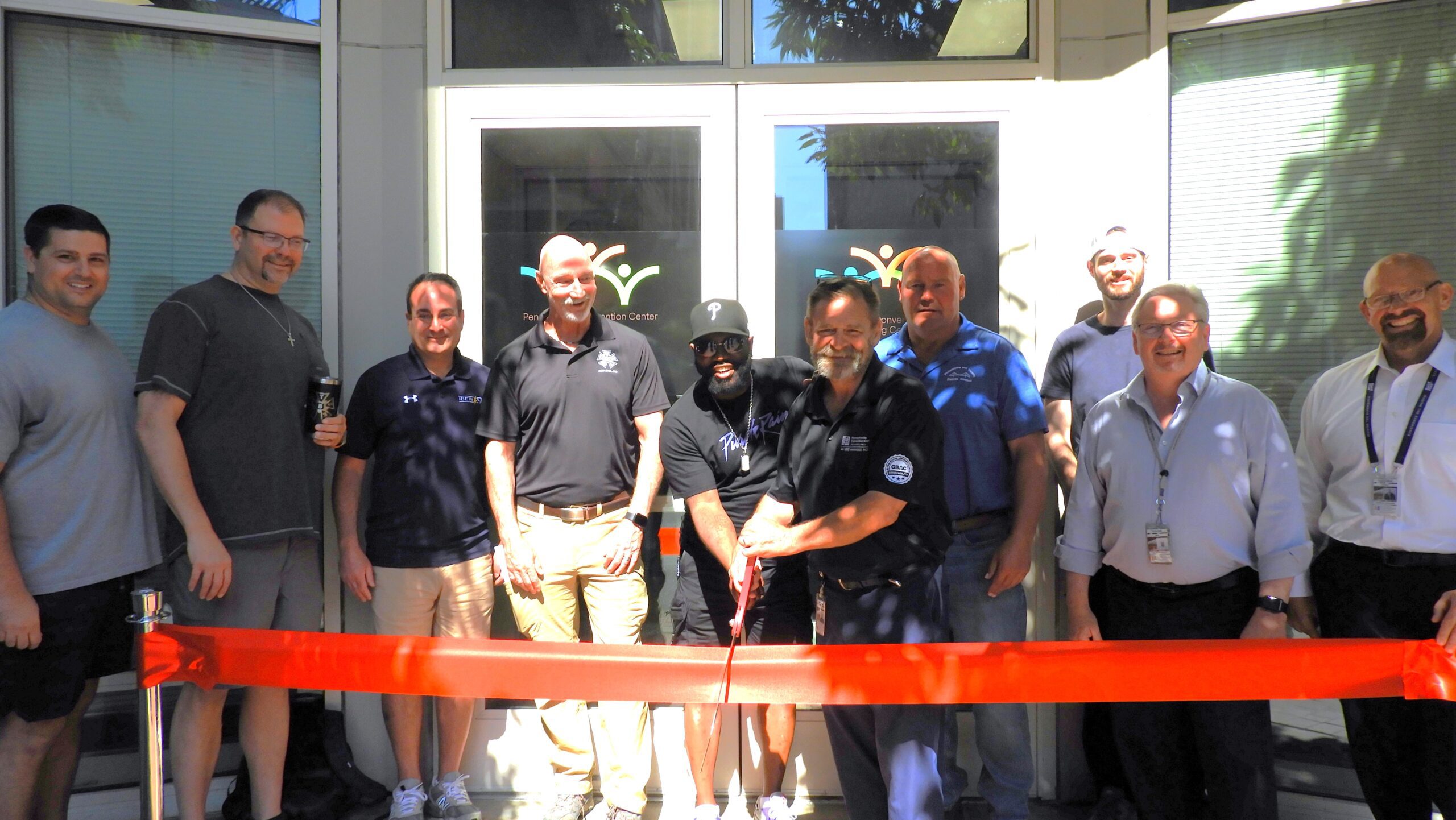 CEO of the Pennsylvania Convention Center, John McNichil cuts the ribbon in front of others to the training center.