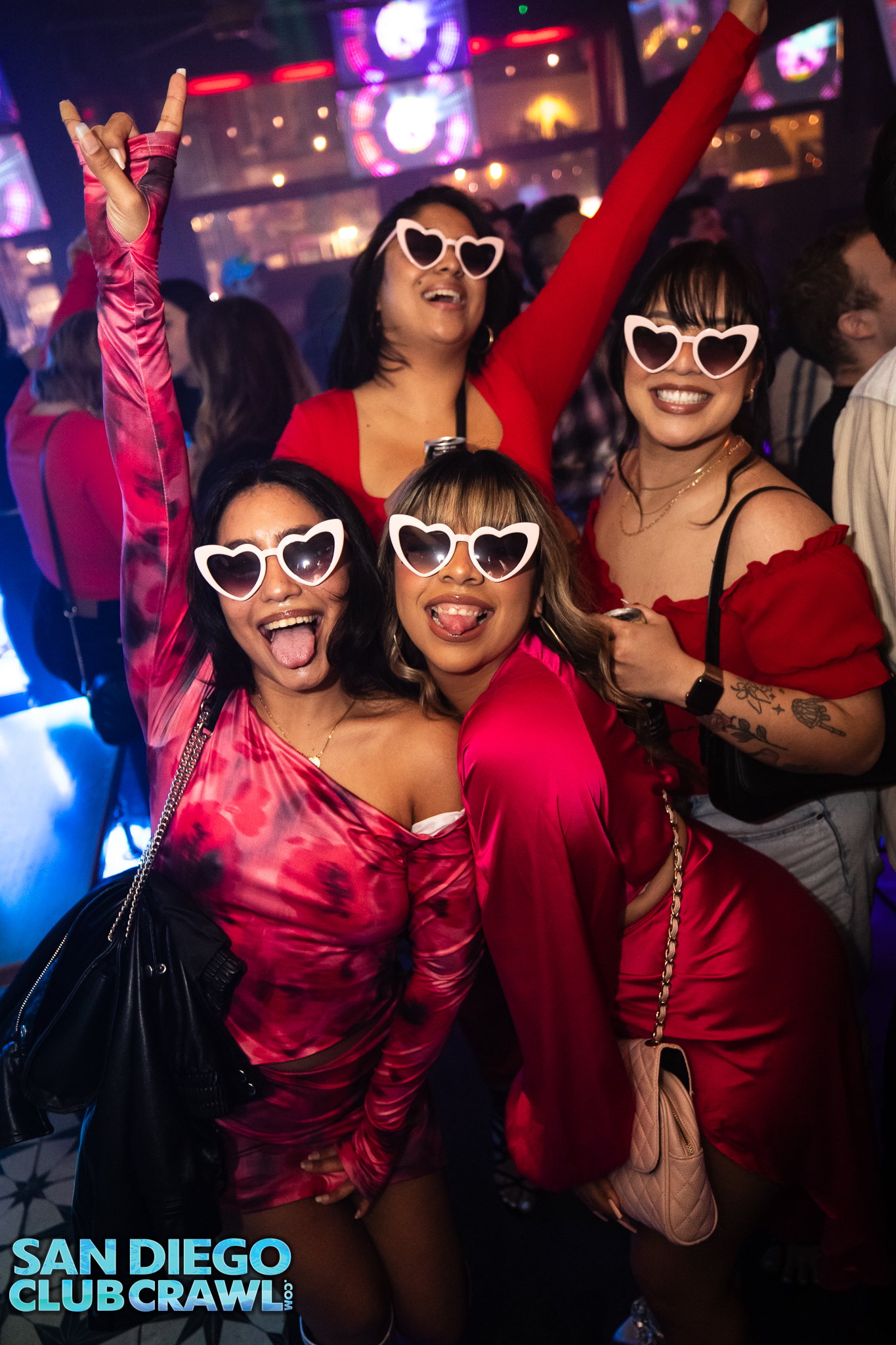 Four women wearing heart sunglasses enjoy San Diego Club Crawl.