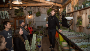 Event organizer teaches workshop attendees about plants