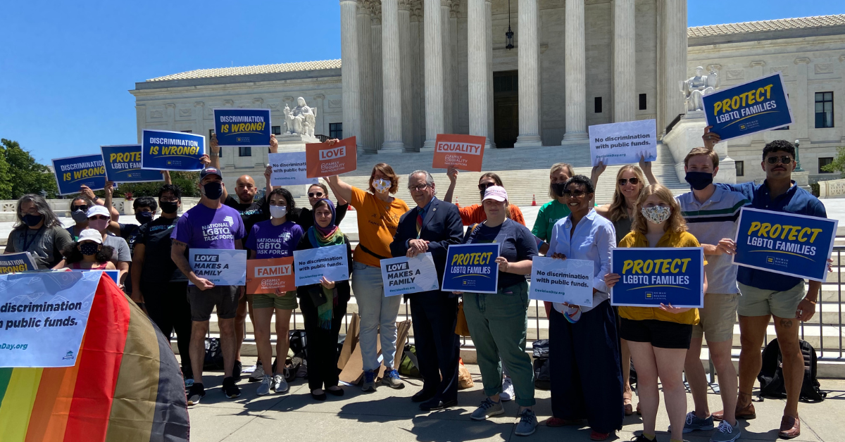 People holding signs in front of the Supreme Court