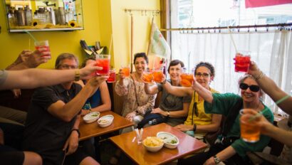 A group cheers with Aperol Spritz in Milan, Italy