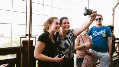 Two women take a selfie on the Eiffel Tower in Paris, France