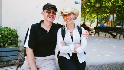 A couple sits on a bench in Montmartre, a neighborhood in Paris, France