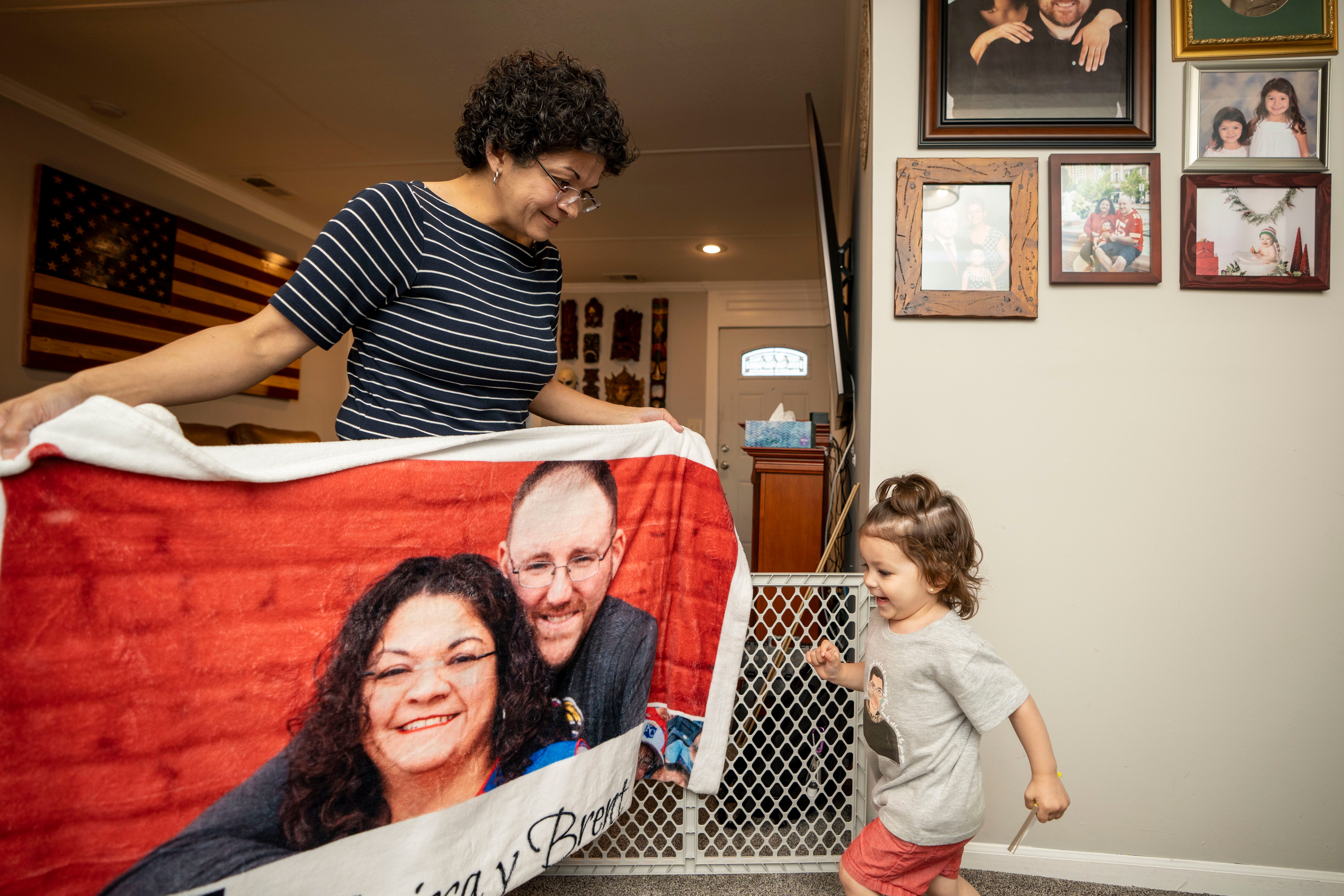 Anissa Parra-Grooms plays with her daughter, Elvira, 2, at their home in Kansas City, Mo., on April 26.