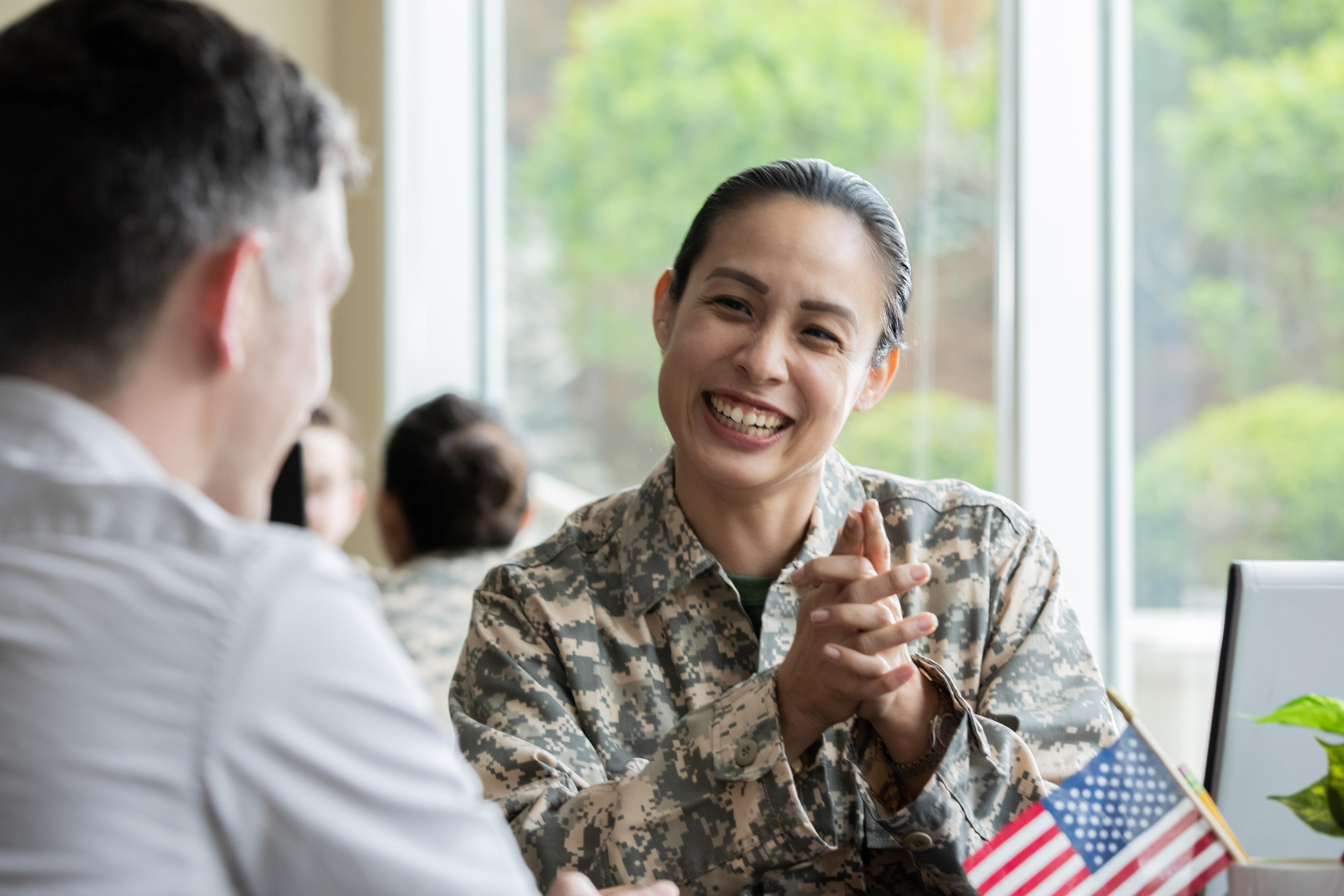 woman in military uniform smiling at man in button down