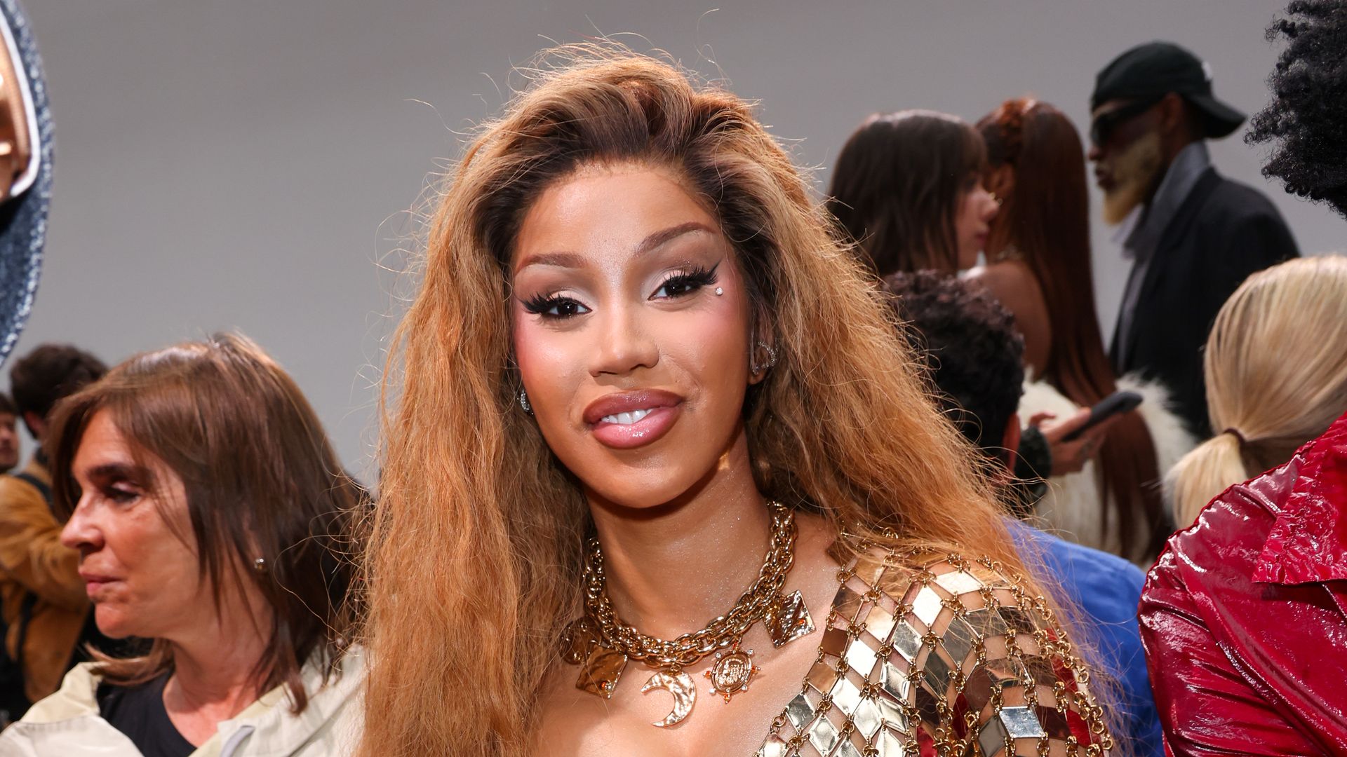 Cardi B channels Shakira in a gold gown during Paris Fashion Week