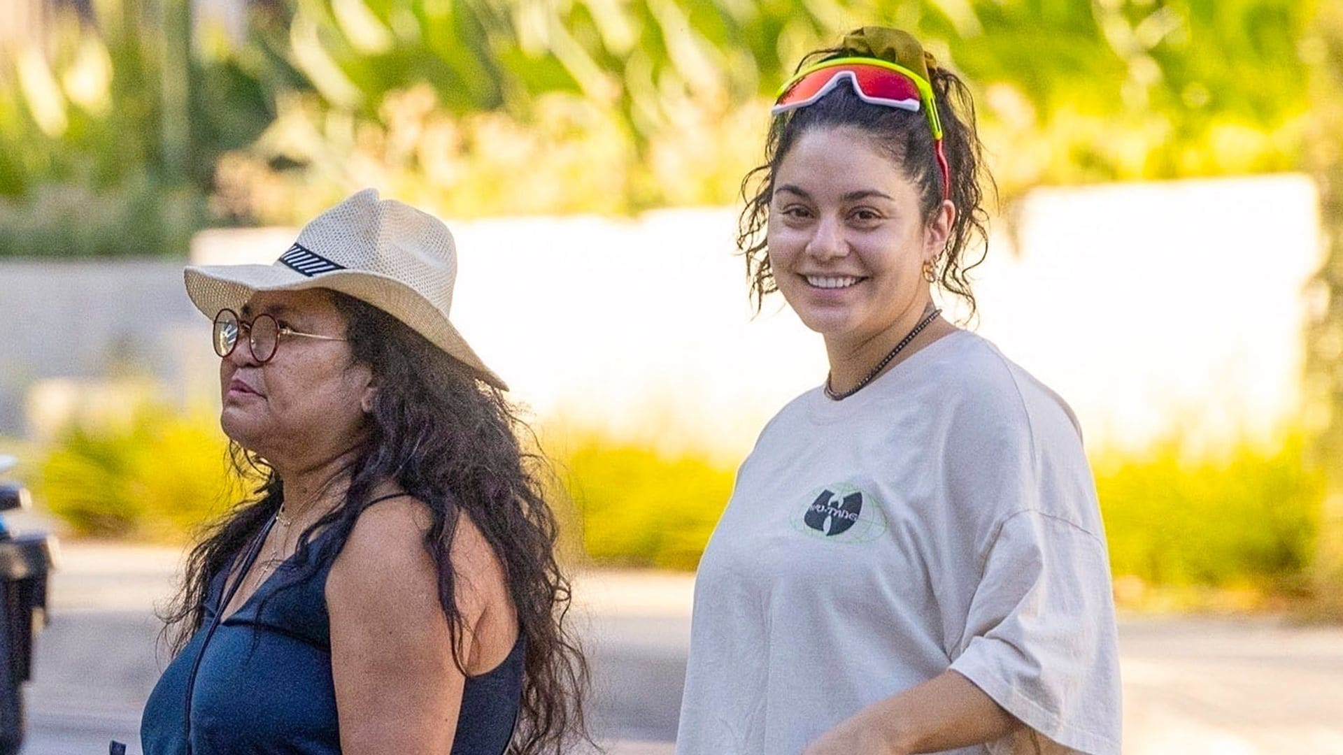 Vanessa Hudgens radiates on a walk with her mom and newborn baby