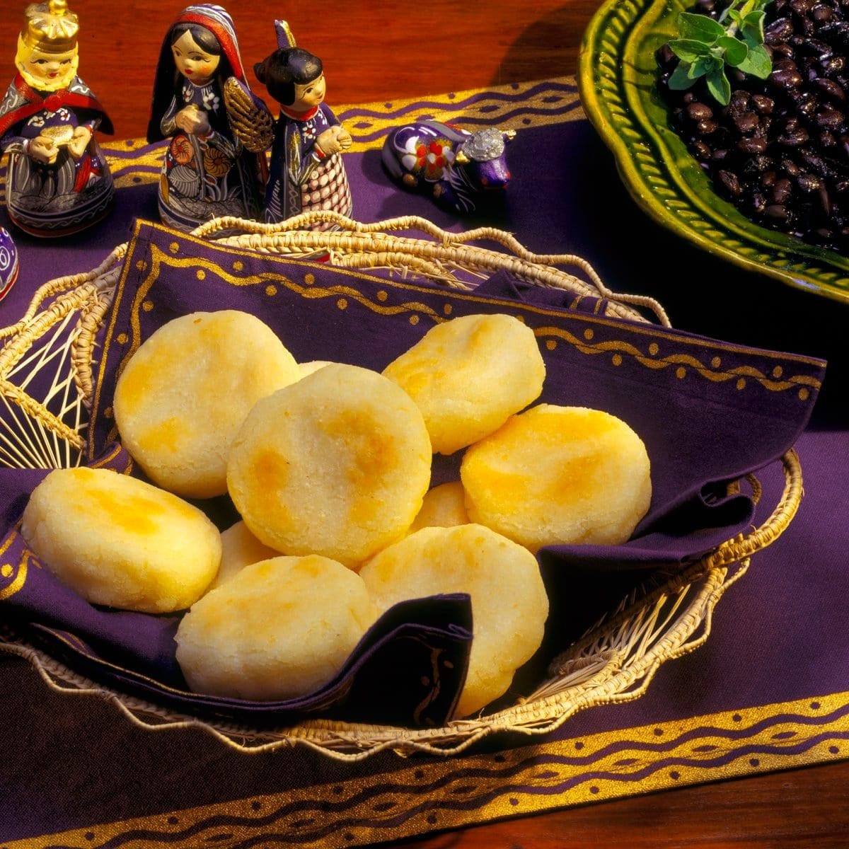 Arepas in a Basket with a Bowl of Black Beans