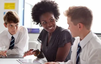 A teacher working with young students.