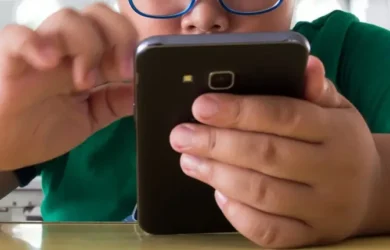 A child holds their smartphone.