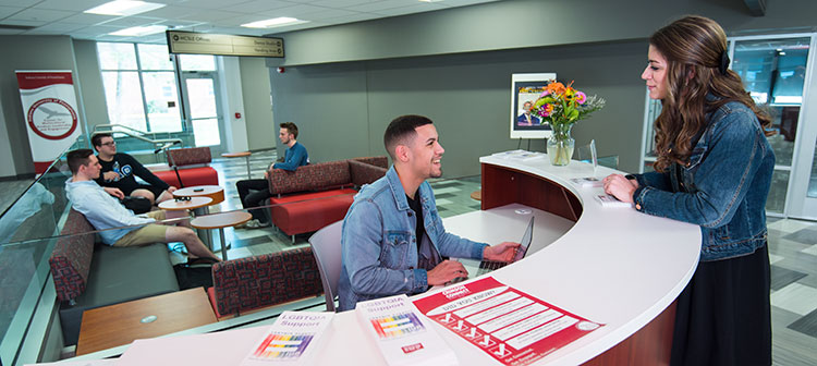 Students talking at the main desk in the Center for Multicultural Student Leadership and Engagement 