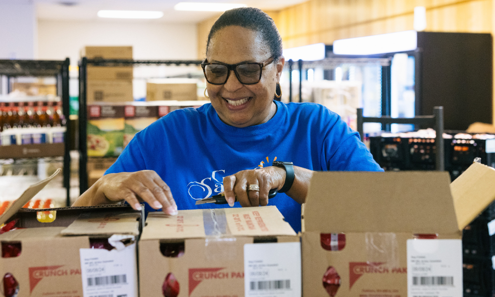 Blue Ridge Area Food Bank volunteer unboxing food