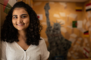 international student, background with statue of liberty and flags