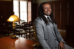 law student sitting on desk in courtroom