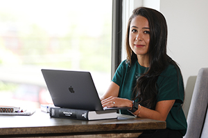 student at desk with laptop