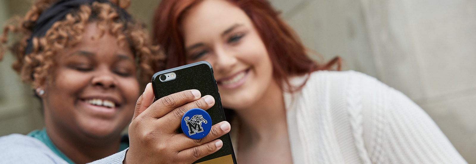 Students looking at a phone