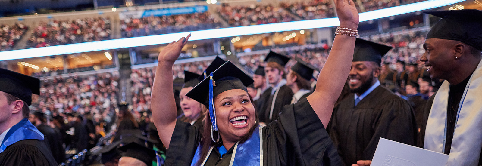 student at commencement celebrates