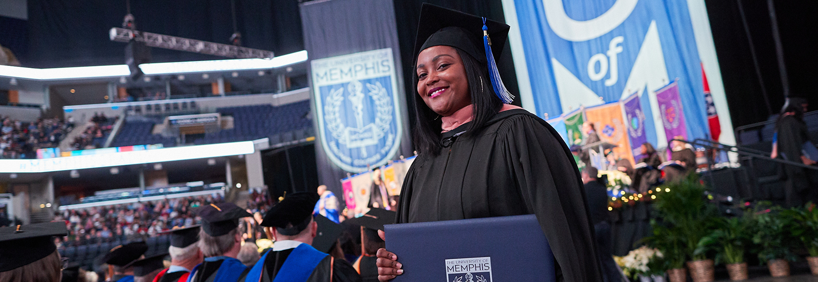 graduate student receives diploma at commencement