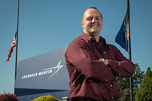 Steven Plutschack with Lockheed Martin sign behind him