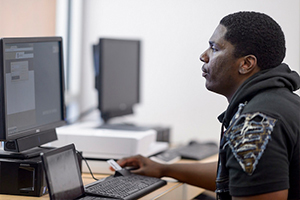 student working on computer in VRC center