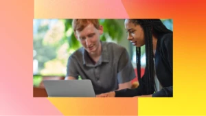 Picture of two people working on a laptop with a pink and yellow background