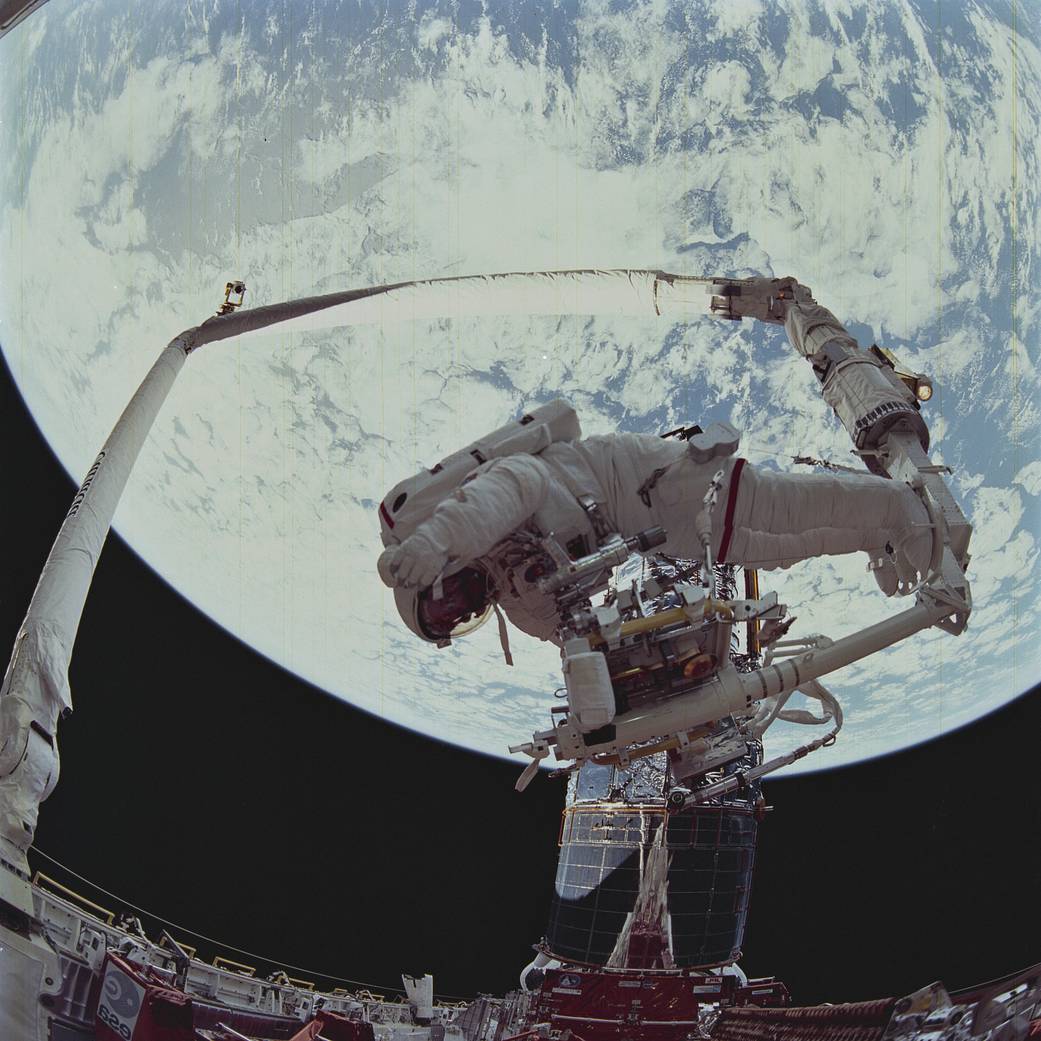 In this Dec. 1993, onboard view from Space Shuttle mission STS-61 shows astronauts Story Musgrave and Jeffrey Hoffman's Extra Vehicular Activity (EVA) to repair the Hubble Space Telescope.