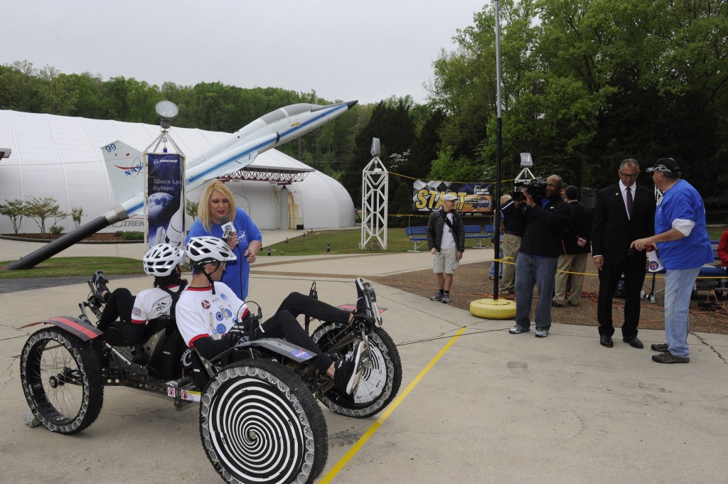 Team participants at the NASA Human Exploration Rover Challenge being interviewed while sitting on their rover