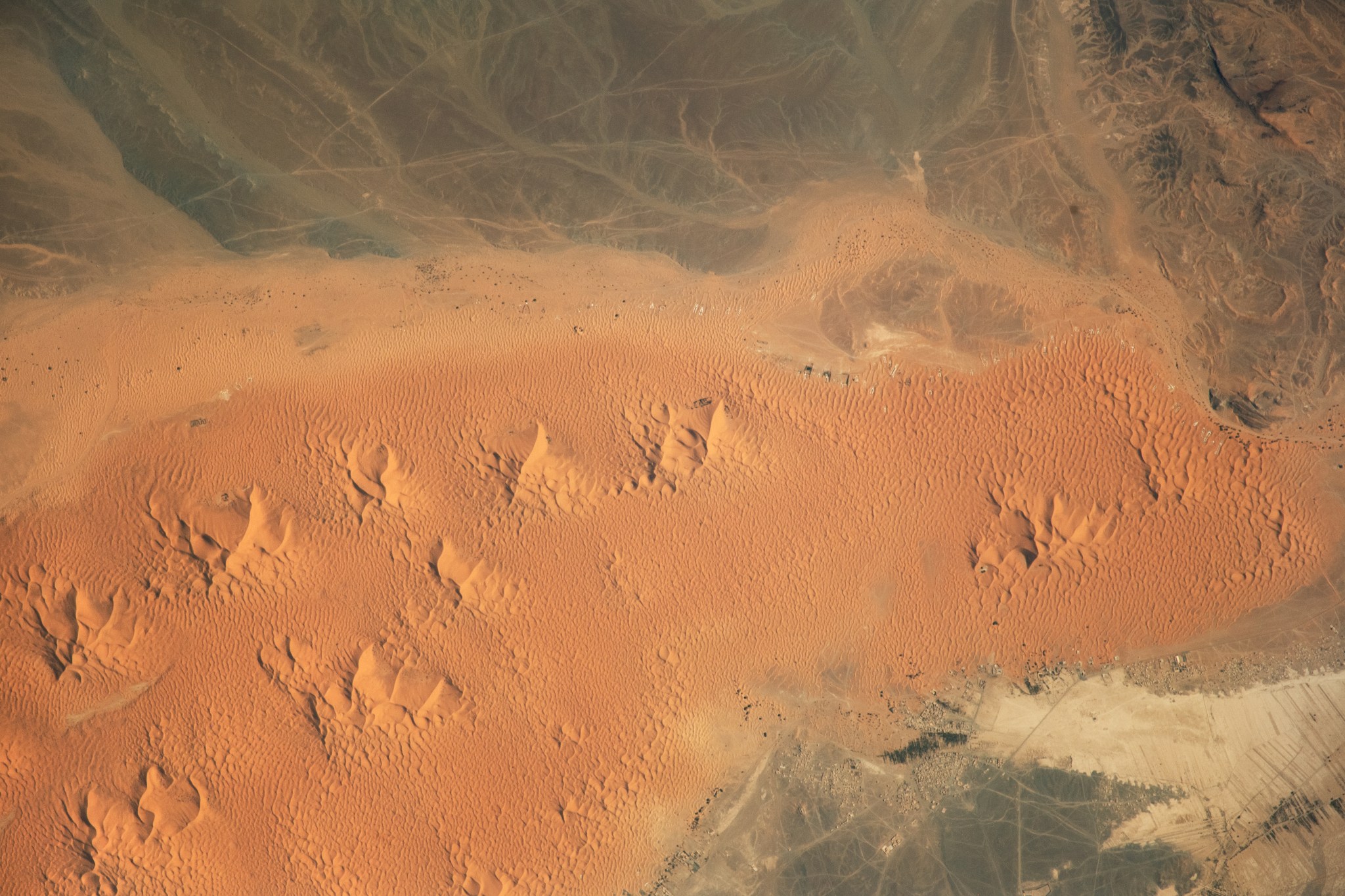 Windswept sand formations known as star dunes, or pyramid dunes, are a distinctive feature of the Sahara Desert in northern Africa.