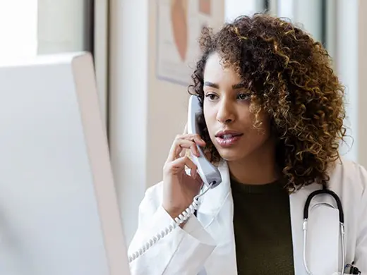 Doctor on the phone looking on the computer