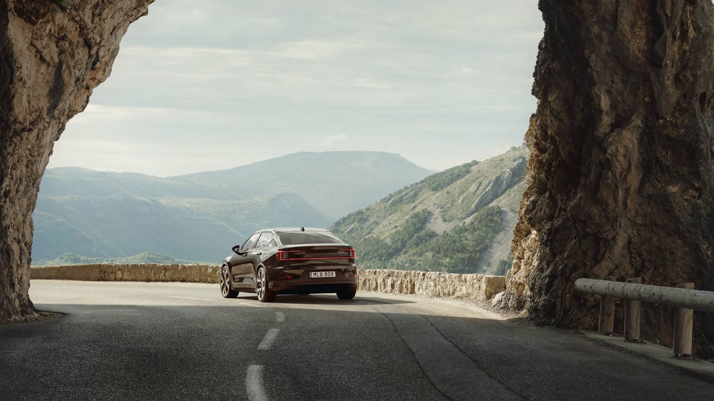 Polestar 2 driving on a road with mountainview