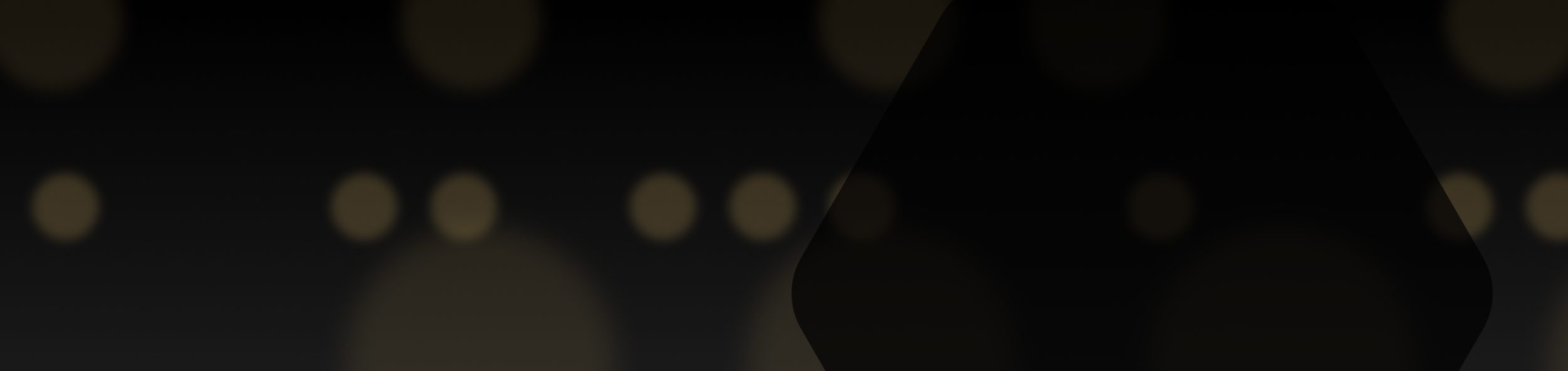 Dark background with faint circular light spots.