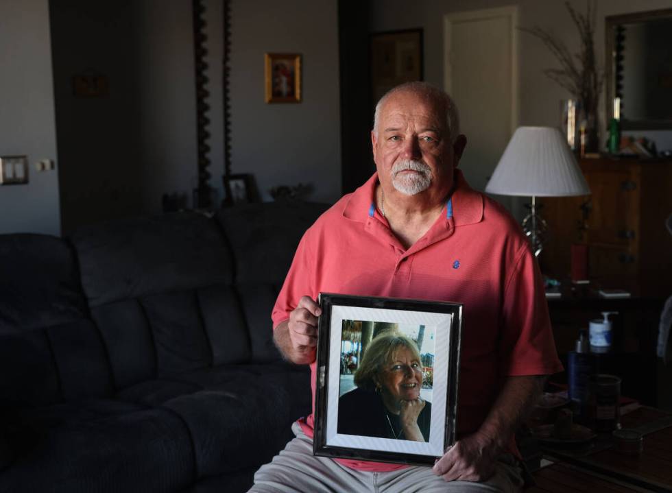 Tim Reiber holds a photo of his wife of nearly 30 years, Judy Reiber, who died from environment ...