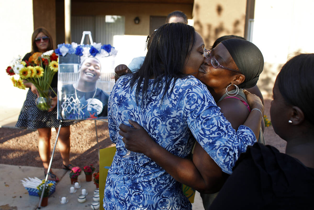 Kimeryn Williams, left, gets a kiss from Trenia Cole during a vigil for Trevon Cole Friday, Jun ...