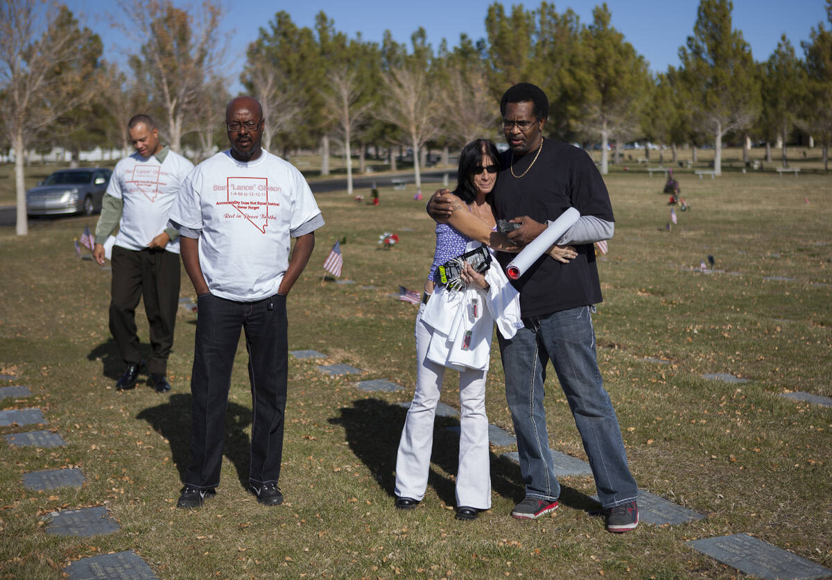 Todd Hudson, right, hugs Rondha Gibson as they visit the grave of Rondha's husband Stanley Gibs ...