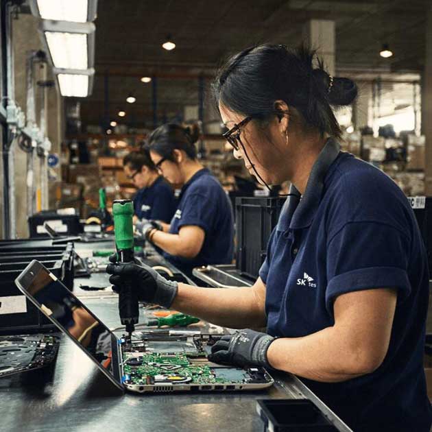 SK tes employee pulling spare parts from laptop