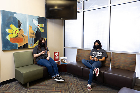 students sitting in chairs in the health services waiting room