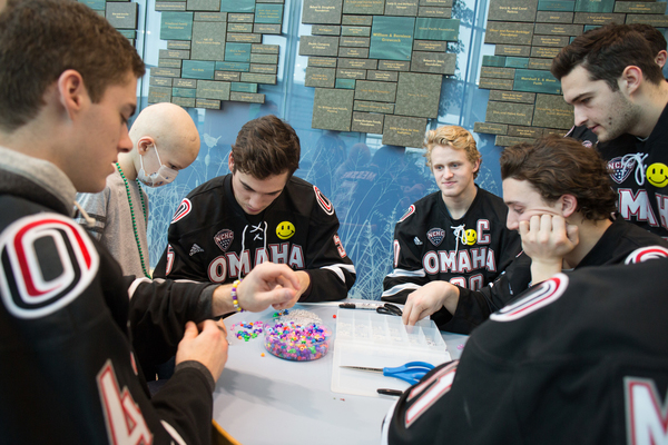 Students participating in a beading craft activity