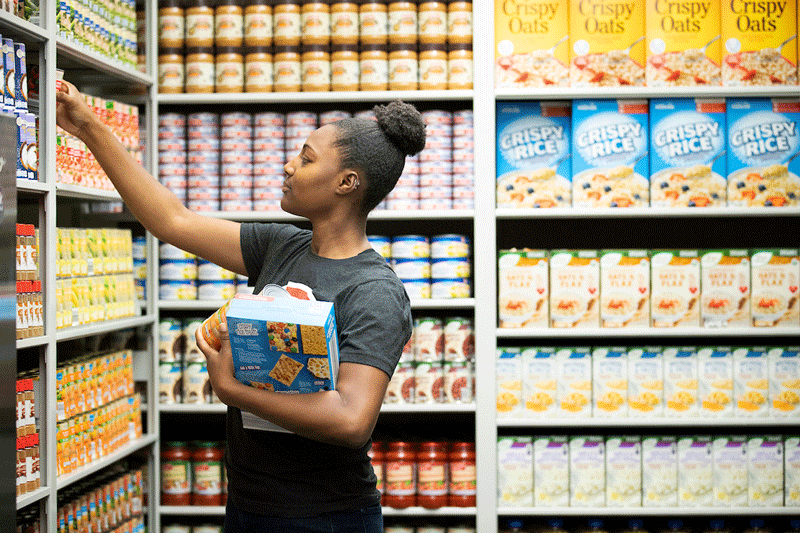 Maverick Food Pantry student worker stocking shelves