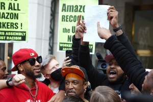 Chris Smalls and ALU leaders holding the tally of ballots showing they won