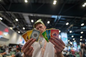 Tom Haynes holding multiple Pokémon cards athe