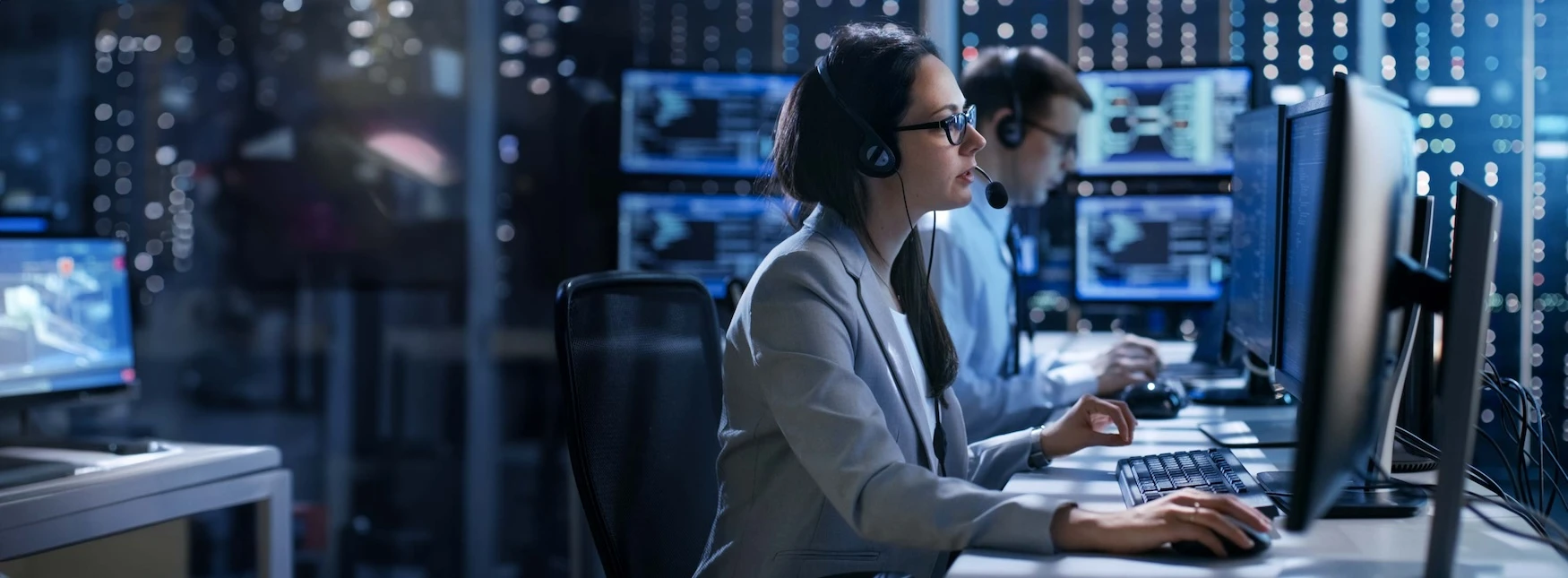 Information technology professionals work on computers in a data room.