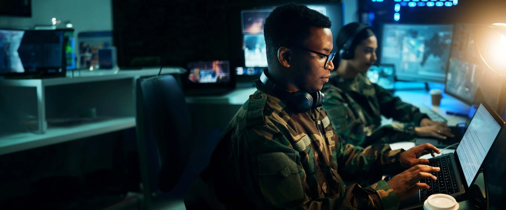 Military personal working on computers in a data room