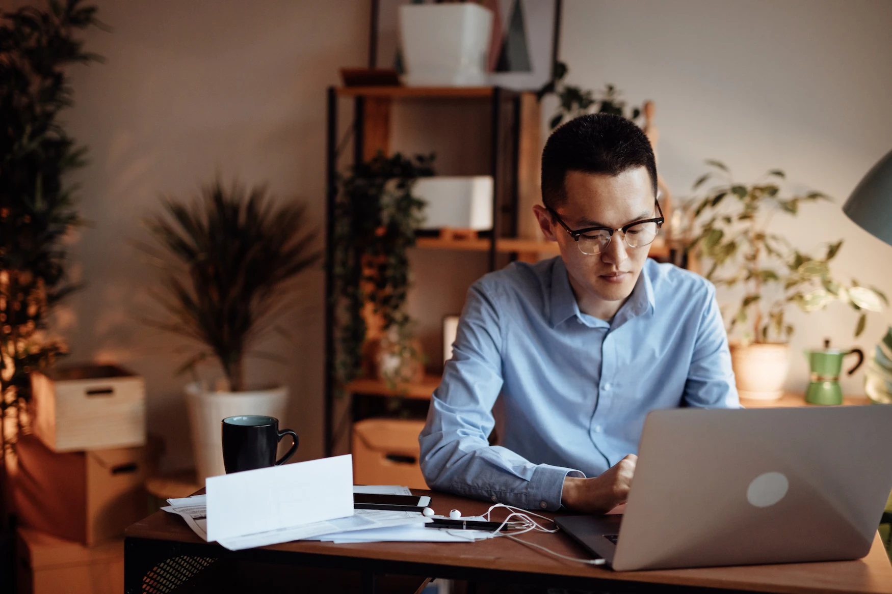 A man works on a laptop in his office.