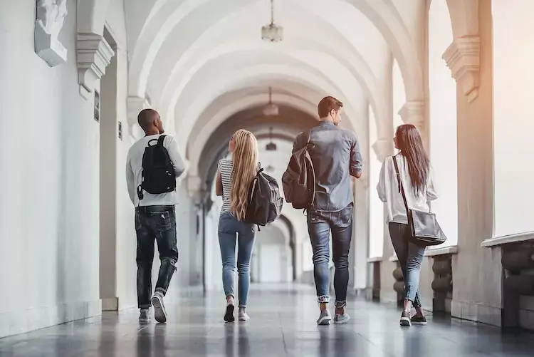 Students walking down an archway. 