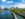 The Philadelphia skyline on a sunny day with the Schuylkill River and Schuylkill Banks Boardwalk in the foreground.