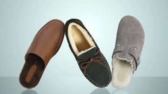 Brown leather slippers from Beckett Simonon, green suede slippers from L. L. Bean and gray suede slippers from Birkenstock on a light blue background. 