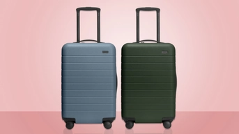 Gray-blue and dark forest green hard-side suitcases on pink background.